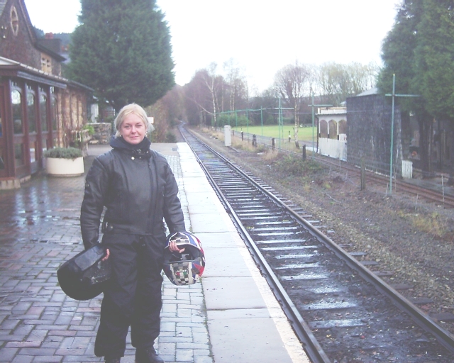 the gf in full wet weather riding gear at betws-y-coed train station